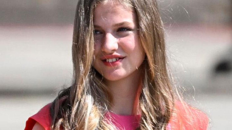 (From L) Spain's Queen Letizia and Spanish Crown Princess of Asturias Leonor wave as they leave on Obradoiro Square after attending the 