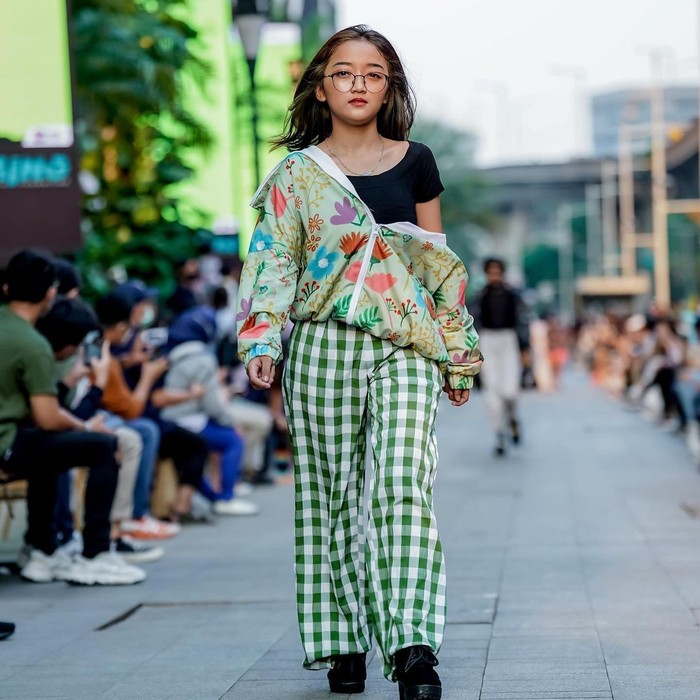 Genis memeragakan busana jaket Calla the Label dengan styling berupa one-shoulder. Foto: Instagram mallkuningancity