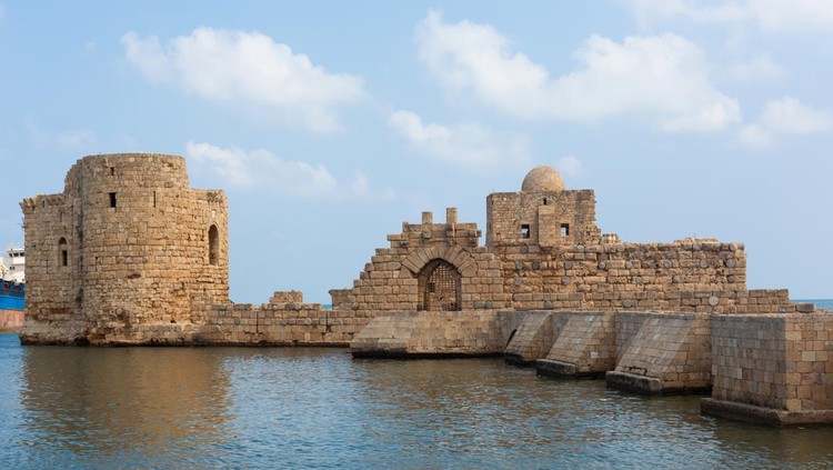 Panoramic view of the Sidon Sea Castle in Lebanon. A beautiful fortress and a stone bridge over the blue water. Lebanese city Sayda on the seaside.