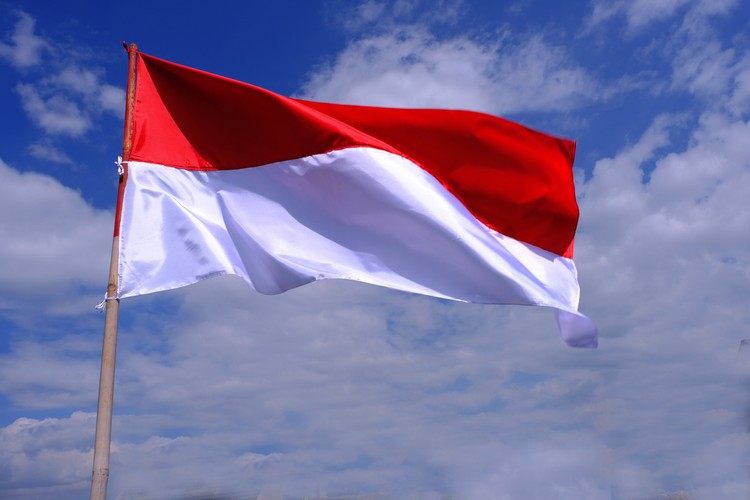 Indonesia Flag Fluttered in the Blue Sky. Indonesian Independence Day in August.