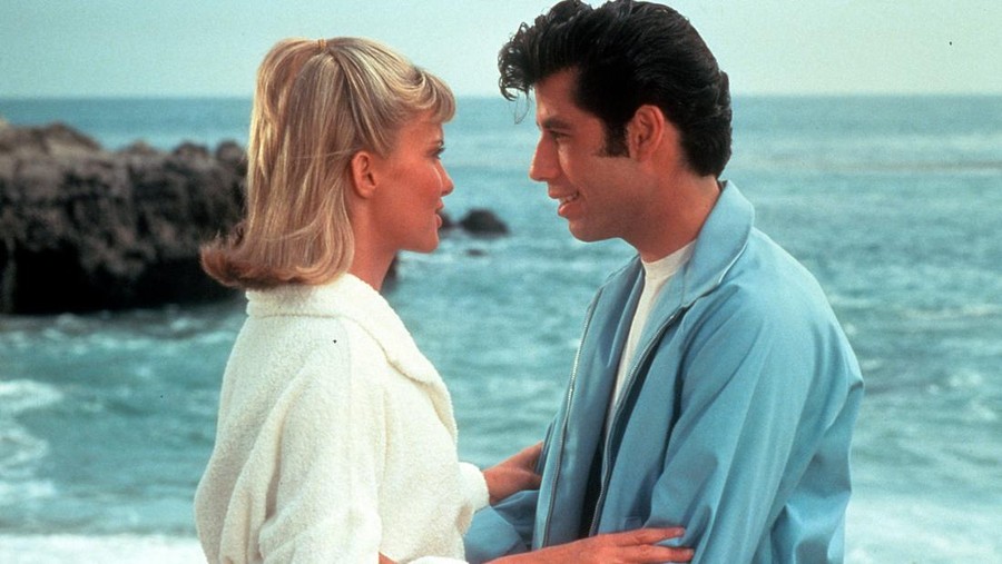 Olivia Newton John and John Travolta embrace on the beach in a scene from the film 'Grease', 1978. (Photo by Paramount/Getty Images)
