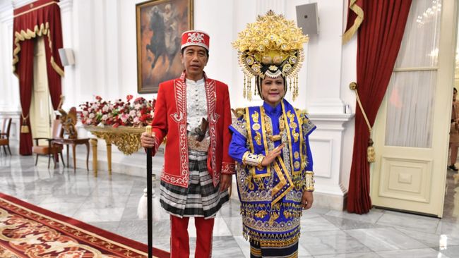 Kompak dengan Presiden Joko Widodo, ibu negara Iriana Jokowi juga mengenakan baju adat suku Buton, lengkap dengan mahkota besarnya. 