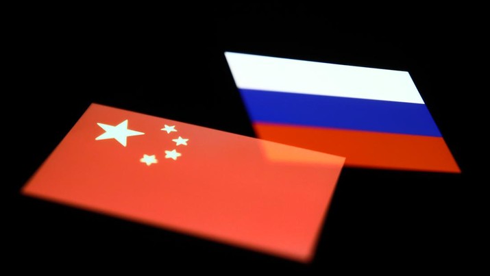 Flags of China and Russia displayed on phone screens are seen in this multiple exposure illustration photo taken in Krakow, Poland on May 15, 2022. (Photo illustration by Jakub Porzycki/NurPhoto via Getty Images)