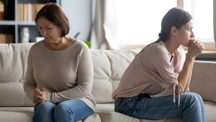 1309167713 Unhappy young woman and mature mother avoiding talking after quarrel, elderly mum and grownup daughter sitting on couch back to back separately, two generations of women conflict concept