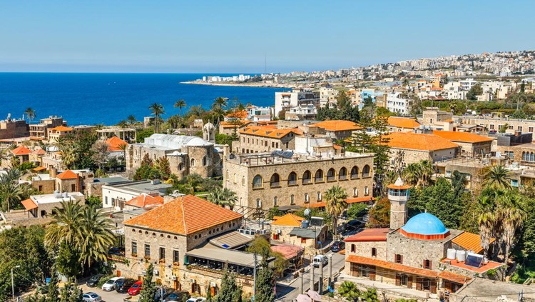 1140180172 Mediterranean city historic center panorama with old church and mosque and residential buildings in the background, Byblos, Lebanon