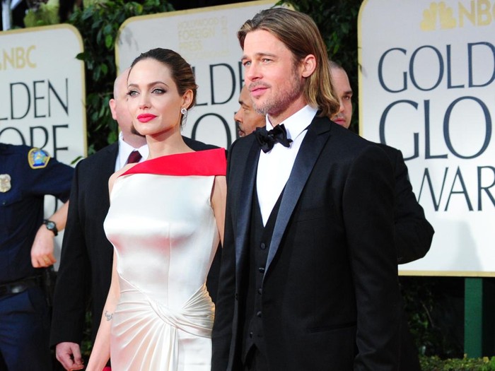 Actors Angelina Jolie and Brad Pitt arrive on the red carpet for the 69th annual Golden Globe Awards at the Beverly Hilton Hotel in Beverly Hills, California, January 15, 2012. AFP PHOTO / Frederic J. BROWN (Photo credit should read FREDERIC J. BROWN/AFP via Getty Images)