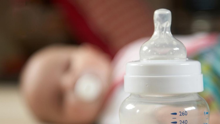 Baby and bottle in focus