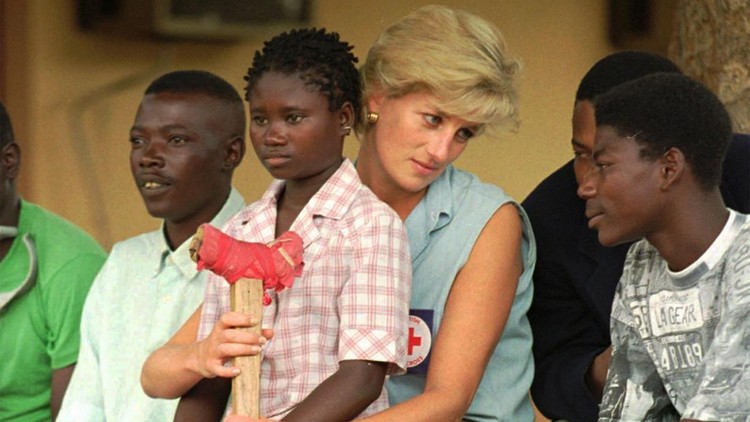 Diana, Princess of Wales, talks to amputees, Tuesday Jan. 14, 1997, at the the Neves Bendinha Orthopedic Workshop in the outskirts of Luanda. Sitting on Diana's lap is 13-year-old Sandra Thijica who lost her left leg to a land-mine while working the land with her mother in Saurimo, eastern Angola, in 1994. Princess Diana is visiting Angola in an effort to create awareness about land-mines. (AP Photo/Joao Silva)