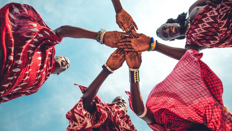 507877508 Masai in traditional clothes joining hands in unity (Zanzibar, Tanzania),