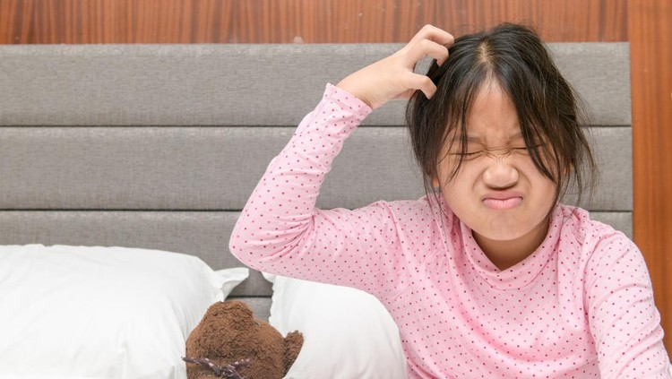 Girl itchy her hair or frustrated on bed, problem Health Hair concept