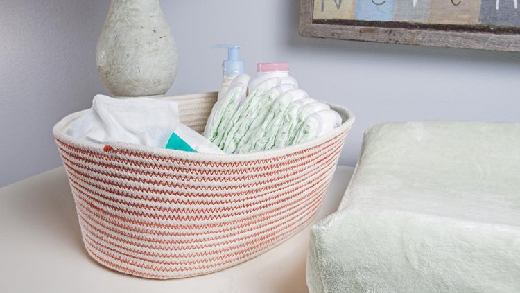 A basket of diapers in a newborn baby's nursery.