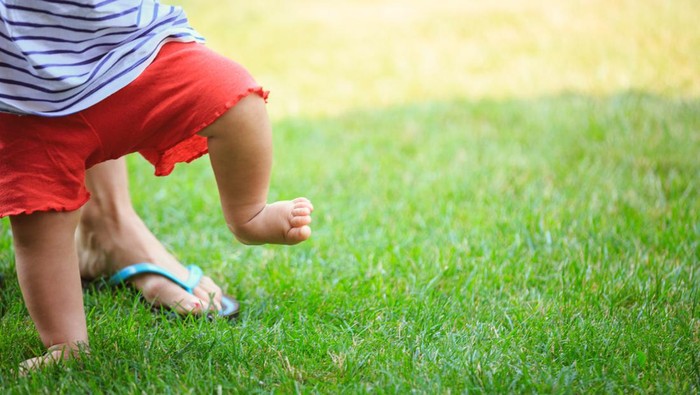 Baby's first steps on the grass.