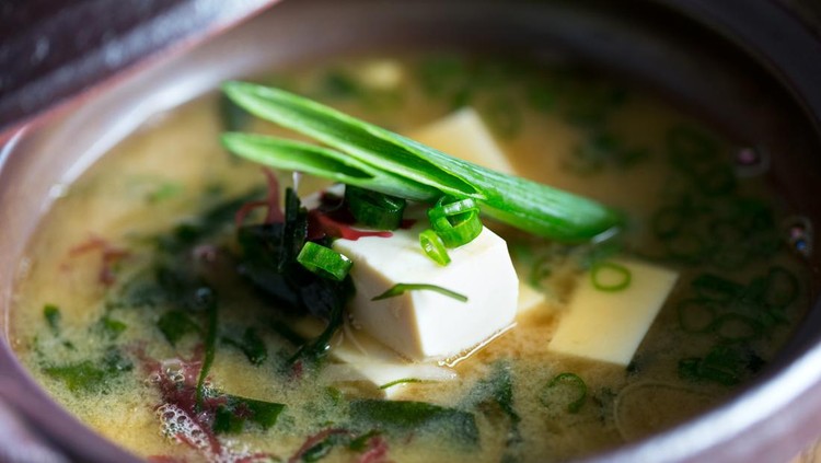 Fresh miso soup in bowl with tofu and mixed vegetables