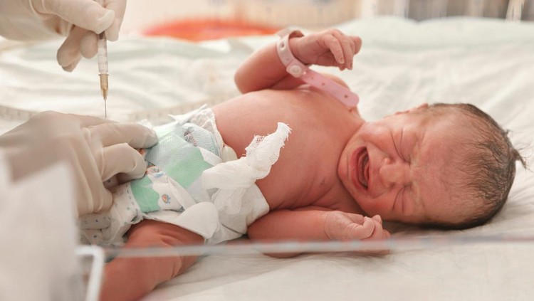 Doctor examines a newborn baby - Turkish ethnicity