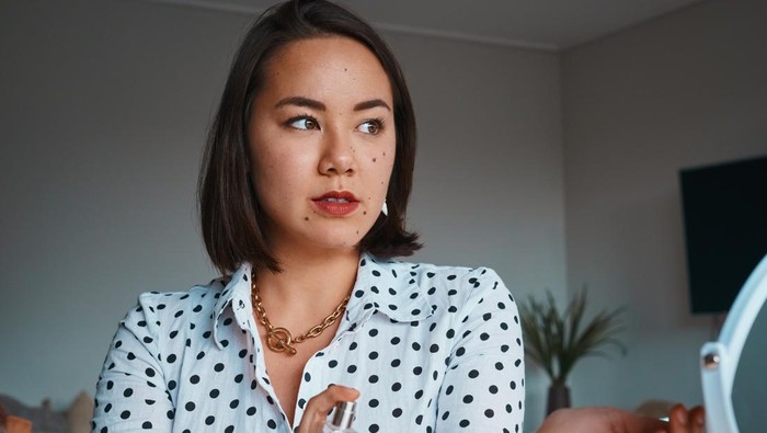 beautiful asian woman in white bathing dress enjoy good smell of new perfume bathroom background