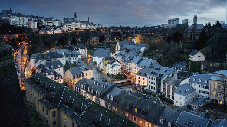 Luxembourg city skyline at night - Aerial view of The Grund with St Michaels Church on background - Luxembourg City, Luxembourg