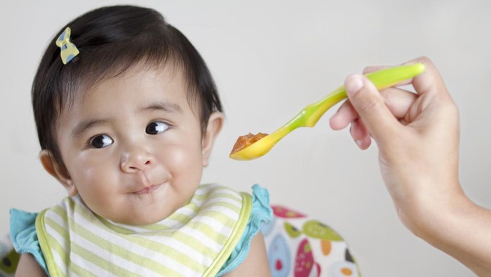 Cute baby not interested in food.