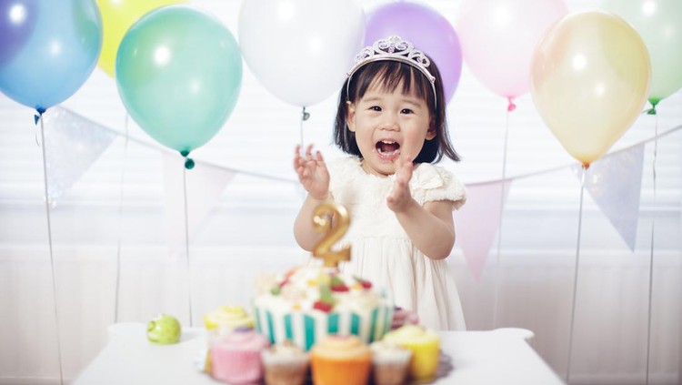 Two years old baby girl celebrating her second  birthday at home