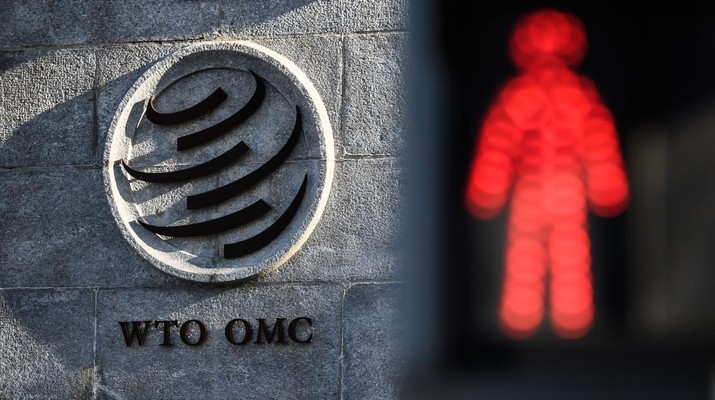 A red pedestrian trafic light is seen next to the entrance of the headquarters of the World Trade Organization (WTO) on December 10, 2019 in Geneva. - WTO announced the launch of 