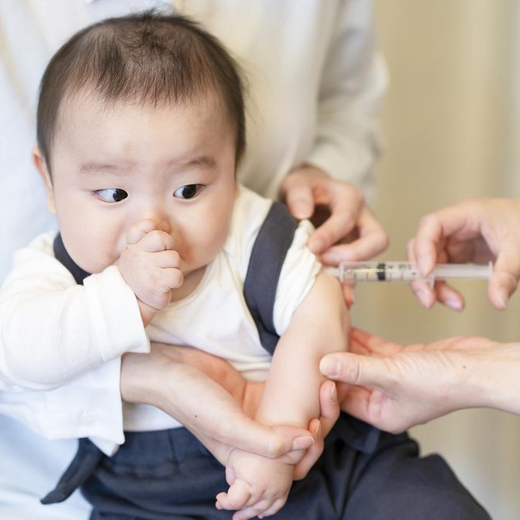 Ilustrasi Imunisasi Sebabkan Autisme A baby who is vaccinated while being held by her mother