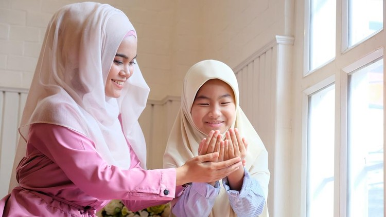 Children learning muslim praying with adult woman.