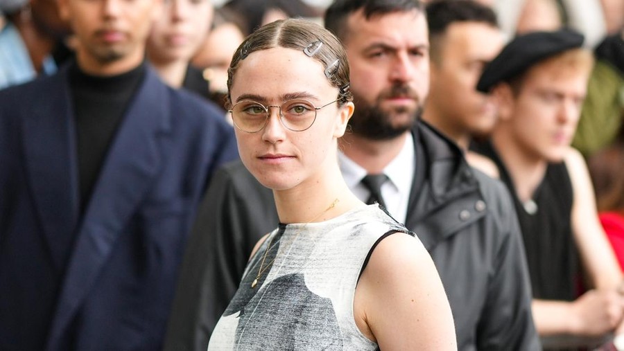 PARIS, FRANCE - JUNE 25: Ella Emhoff wears glasses, a silver pendant chain necklace, a black / gray print pattern tank-top tube long dress, black hair clips, outside the Loewe show, during Paris Fashion Week - Menswear Spring/Summer 2023, on June 25, 2022 in Paris, France. (Photo by Edward Berthelot/Getty Images)