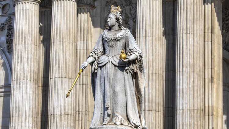 London, UK - April 20th 2022: Statue of Queen Anne with the magnificent facade of St. Pauls Cathedral in the background, in the city of London, UK.