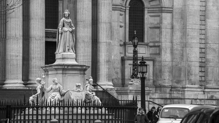 London, UK - April 20th 2022: Statue of Queen Anne with the magnificent facade of St. Pauls Cathedral in the background, in the city of London, UK.