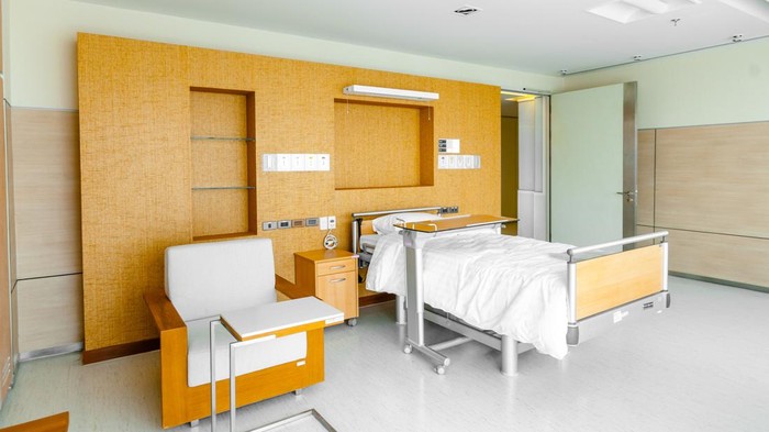 Hospital ward with bed and medical equipment