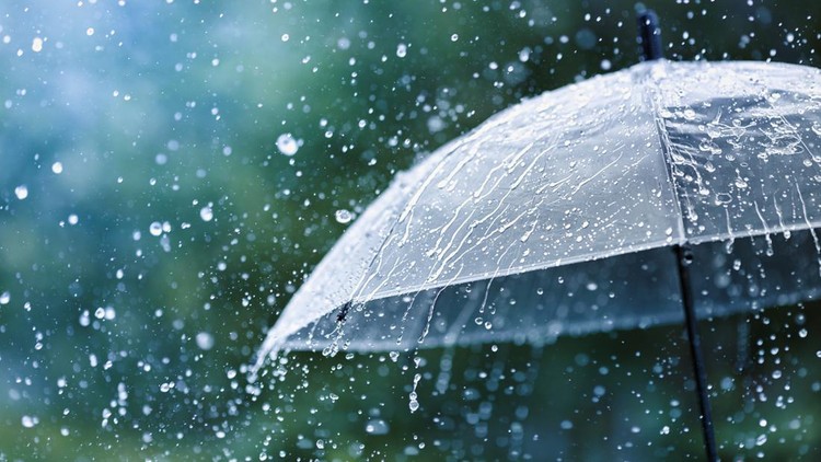 Transparent umbrella under heavy rain against water drops splash background. Rainy weather concept.