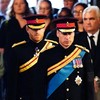 Queen Elizabeth II 's grandchildren (L-R) Britain's Prince Harry, Duke of Sussex (L) and Britain's Prince William, Prince of Wales (R) arrive to hold a vigil around the coffin of Queen Elizabeth II, in Westminster Hall, at the Palace of Westminster i