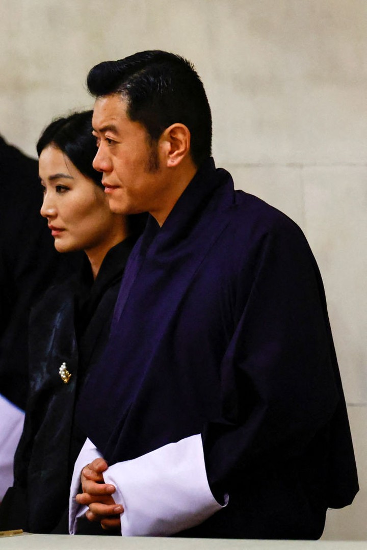 LONDON, ENGLAND - SEPTEMBER 18: Bhutan's King Jigme Khesar Namgyel Wangchuck and Queen Jetsun Pema gesture as they pay their respects  as they view the coffin of Queen Elizabeth II lying in state at Westminster Hall on September 18, 2022 in London, England. Members of the public are able to pay respects to Her Majesty Queen Elizabeth II for 23 hours a day from 17:00 on September 18, 2022 until 06:30 on September 19, 2022.  Queen Elizabeth II died at Balmoral Castle in Scotland on September 8, 2022, and is succeeded by her eldest son, King Charles III.(Photo by John Sibley-WPA Pool/Getty Images)