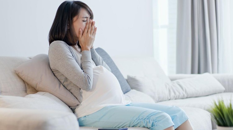 pregnant woman look smart phone and feel depression at home