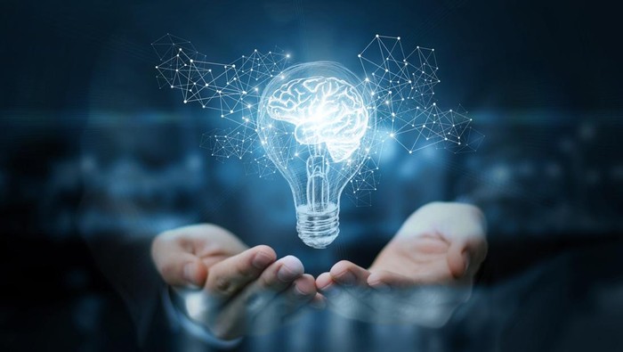 Light bulb with brain inside the hands of the businessman. The concept of the business idea.