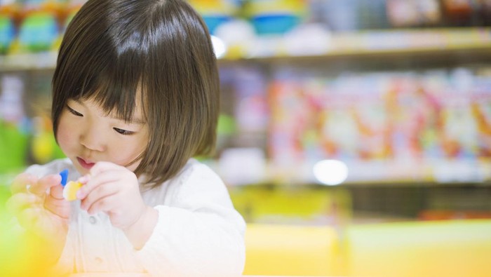 3-years-old girl have colorful toys.