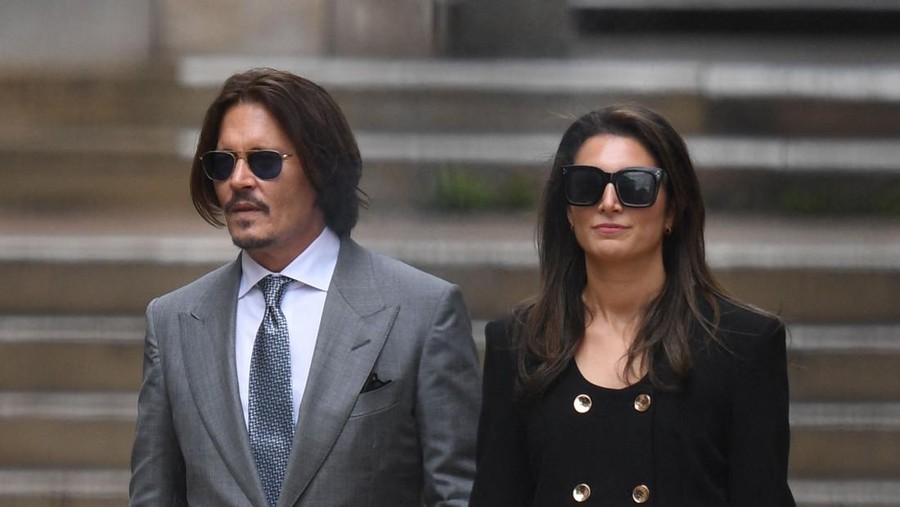 US actor Johnny Depp (L) leaves with members of his team after day eight of his libel trial against News Group Newspapers (NGN) at the High Court in London, on July 16, 2020. - Depp is suing the publishers of The Sun and the author of the article for the claims that called him a 