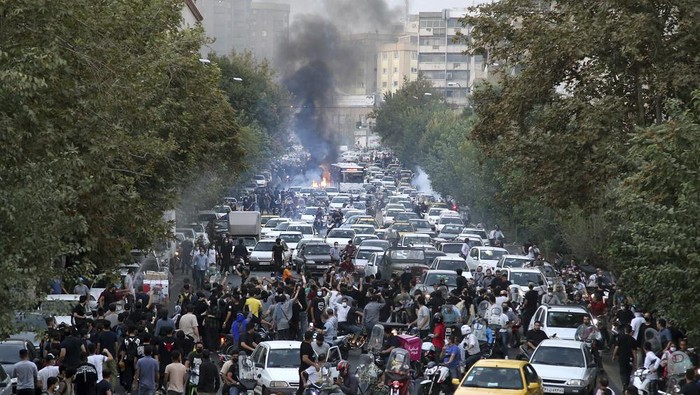 In this Wednesday, Sept. 21, 2022, photo taken by an individual not employed by the Associated Press and obtained by the AP outside Iran, protesters chant slogans during a protest over the death of a woman who was detained by the morality police, in downtown Tehran, Iran. Iranians saw their access to Instagram, one of the few Western social media platforms still available in the country, disrupted on Wednesday following days of the mass protests. (AP Photo)