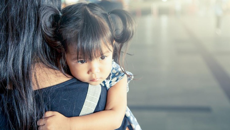 518120042 Mother and child,cute little girl resting on her mother's shoulder in the train station, vintage filter effect,selective focus