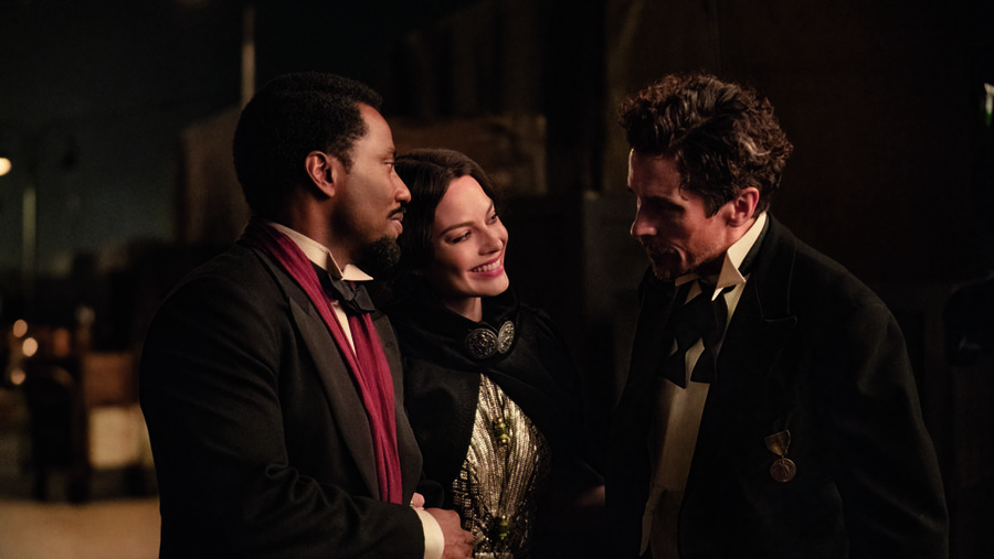 (L-R): John David Washington as Harold Woodman, Margot Robbie as Valerie Voze, and Christian Bale as Burt Berendsen in 20th Century Studios' AMSTERDAM. Photo by Merie Weismiller Wallace; SMPSP. © 2022 20th Century Studios. All Rights Reserved.