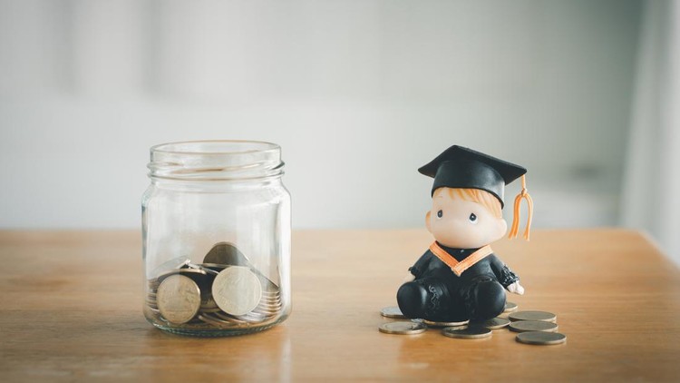 Education savings concept. Coins in a glass jar for education money savings with a graduate doll. Personal financial planning for the future.