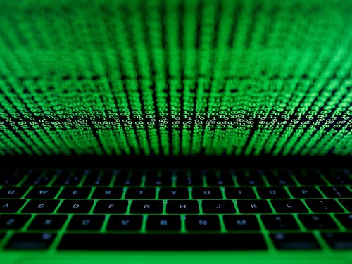 FILE PHOTO: A computer keyboard lit by a displayed cyber code is seen in this illustration picture taken on March 1,  2017. REUTERS/Kacper Pempel/Illustration/File Photo