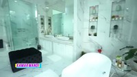 <p>Kamar mandi di kamar utamanya pun sangat mewah bernuansa putih dan dilengkapi dengan sofa di tengahnya. (Foto: YouTube TRANS7 OFFICIAL)</p>
