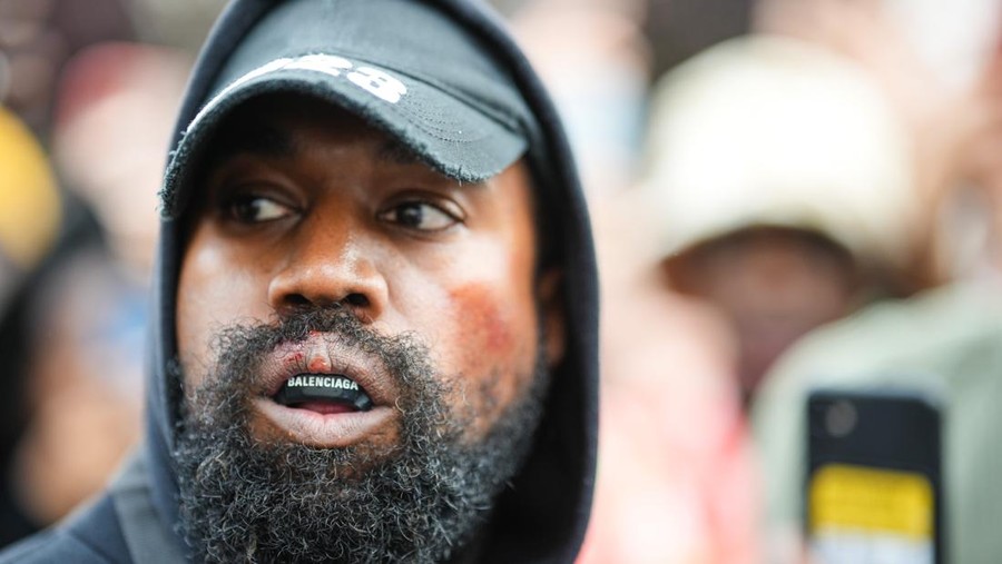 Kanye West PARIS, FRANCE - OCTOBER 02: Kanye West aka Ye is seen wearing a Balenciaga boxing mouthguard, outside Givenchy, during Paris Fashion Week - Womenswear Spring/Summer 2023 - Day Seven on October 02, 2022 in Paris, France. (Photo by Edward Berthelot/GC Images)