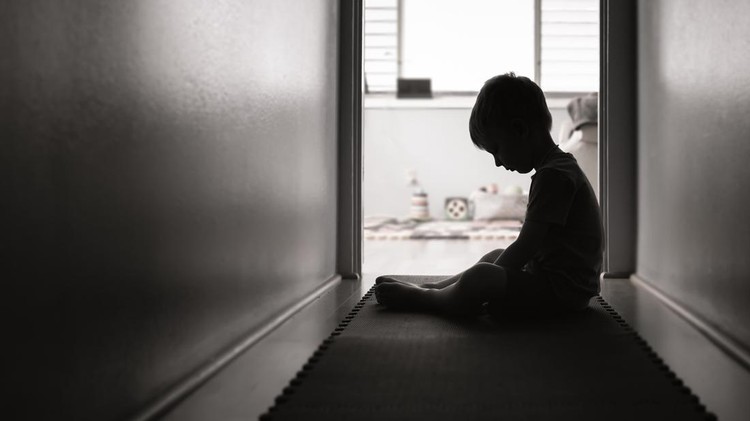 Sad boy sits alone.
