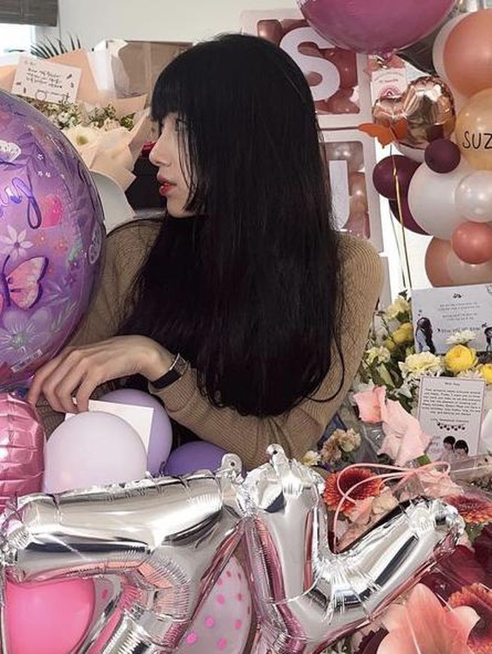 Dalam foto tersebut, terlihat Suzy berpose bersama lautan hadiah, bunga, dan balon pemberian para penggemarnya./ foto: instagram.com/skuukzky