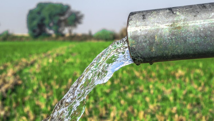 high pressure crystal bluish sweet water flushing out of an agriculture industrial tube well in fields