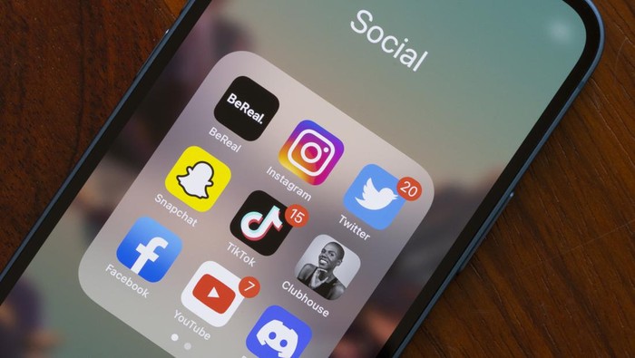 Portland, OR, USA - Aug 23, 2022: Assorted popular social media apps - BeReal, Instagram, Twitter, Snapchat, TikTok, Clubhouse, Facebook, YouTube, and Discord - are seen on an iPhone. BeReal is a French social media app rising in popularity, and can be anti-social in some ways. Users receive a notification at a random time once a day saying 'Time to BeReal'. This opens up a two-minute window for the user to post a picture of what they are currently doing. The purpose of this is to capture an authentic, unfiltered snapshot of a user's life.