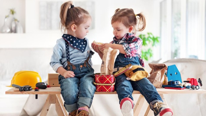 Two little girls sharing lunch