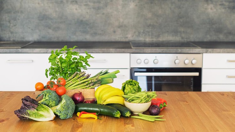 Fresh farm fruit and vegetables at the kitchen counter