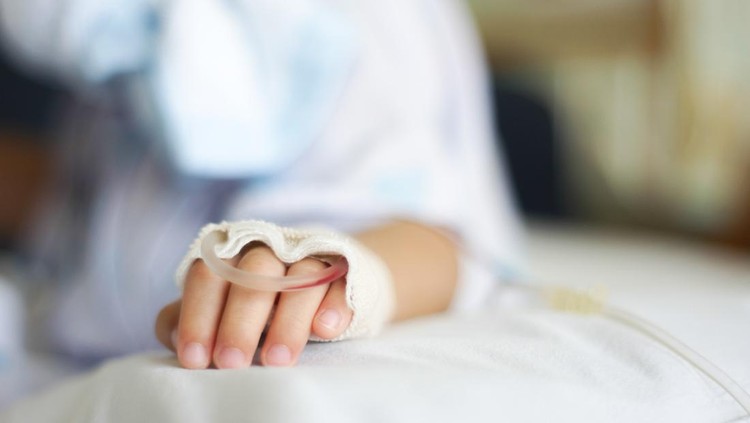 Saline intravenous (iv) drip in a Children's patient hand